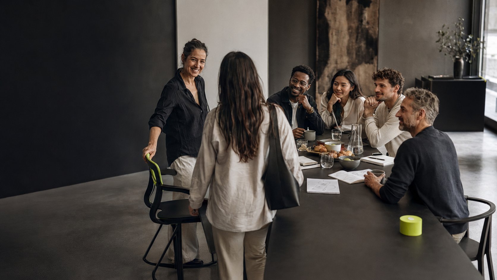 A small group of founders in conversation around a table